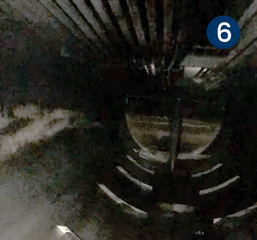 Dimly lit industrial spiral staircase with metal railings and blue number six sign, related to cleaning of a first stage horizontal separator.
