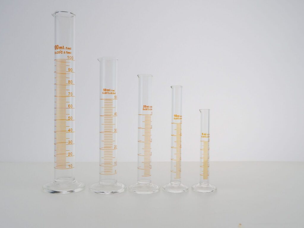 Laboratory graduated cylinders representing EN 14214 biodiesel specification limits