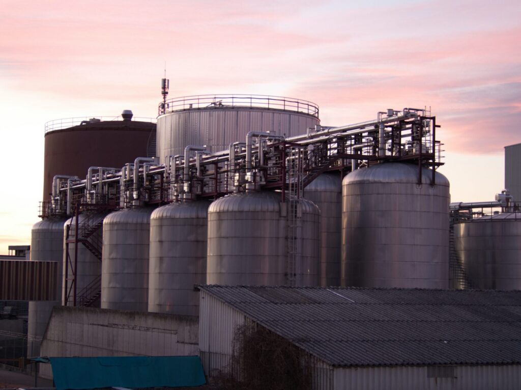Refinery tanks and pipework used in oil sludge treatment and hydrocarbon recovery
