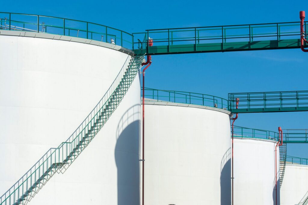Storage tanks with access walkway where tank cleaning chemicals are applied