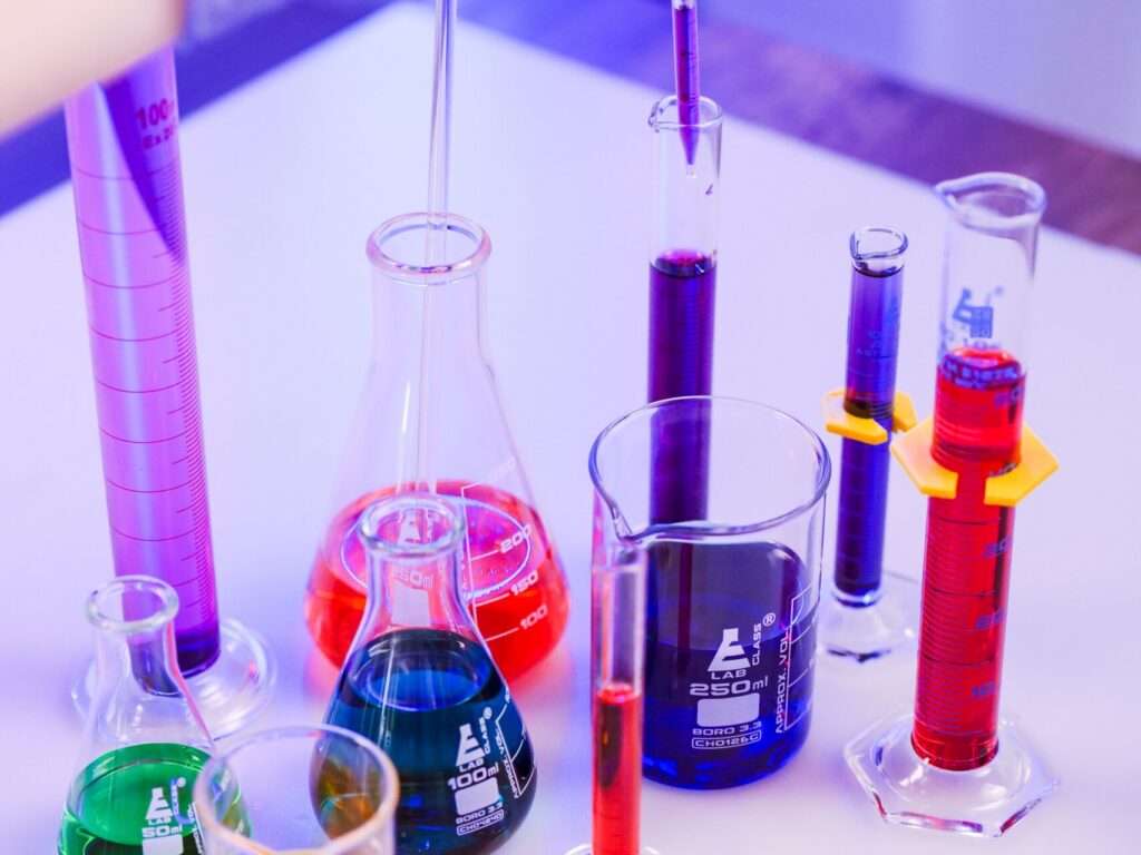 Laboratory glassware with chemical solutions representing TBHQ antioxidant dosing