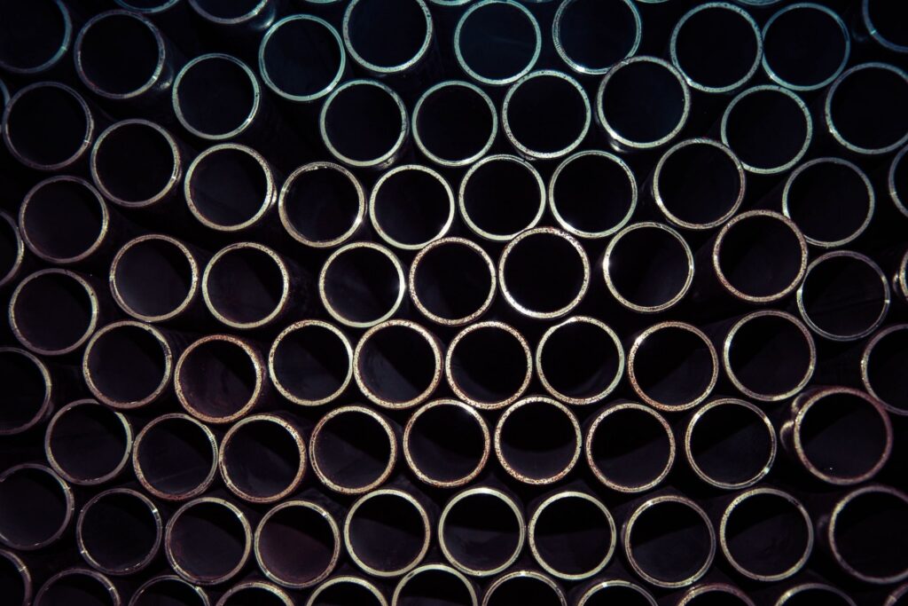 Close-up of steel tube ends in a tight bundle, like the tube bundles cleaned during industrial descaling