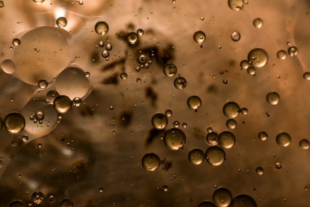 Macro photo of water droplets dispersed in oil, a water-in-oil emulsion