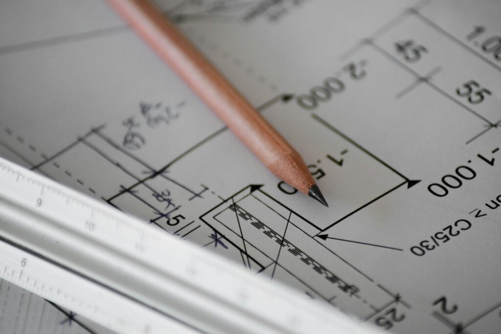 Technical drawing with dimensions and a pencil, representing VRU design and sizing work
