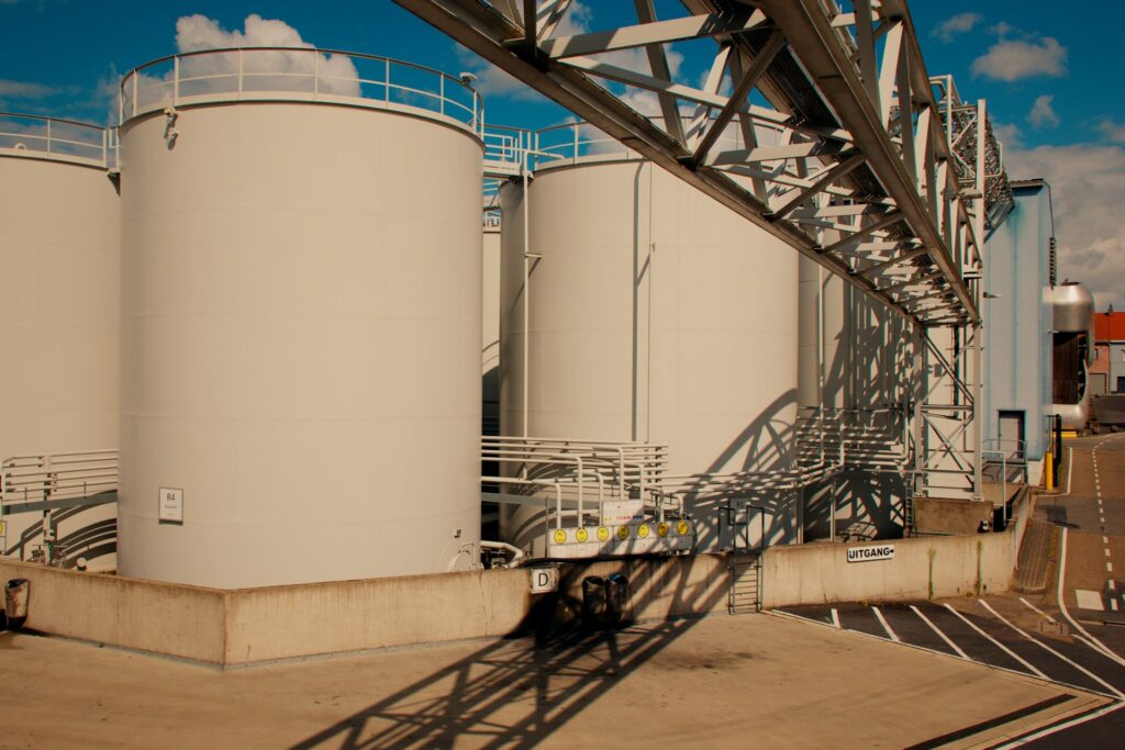 Industrial storage tanks with an overhead pipe rack, where tank vapours are collected by a vapour recovery unit